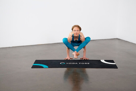 smiling caucasian woman performing yoga shoulder pressing pose while  exercising on green lawn Stock Photo by LightFieldStudios