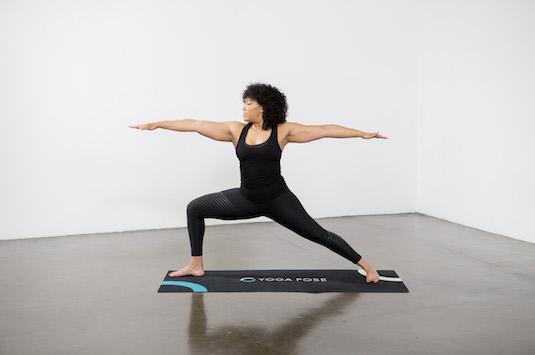 Yoga practice shows lateral yoga flow with warrior 1 pose in a sun  salutation