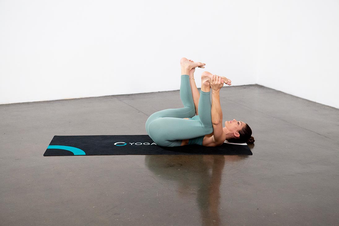 Young Sporty Attractive Woman Practicing Yoga, Doing Happy Baby Exercise, Ananda  Balasana Pose, Working Out, Wearing Sportswear, Grey Pants, Top, Indoor  Close Up, At Yoga Studio Stock Photo, Picture and Royalty Free