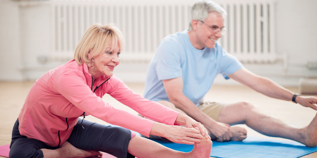 elderly-couple-practicing-yoga