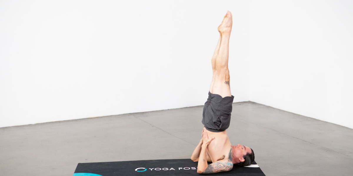 man-practicing-supported-shoulder-stand